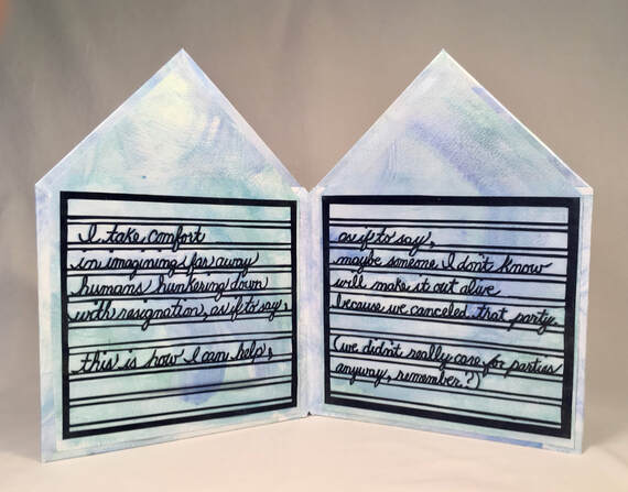 papercut book opened to first two pages of poem. each page is shaped like the outline of a house. text is written in cursive from cut paper and says 